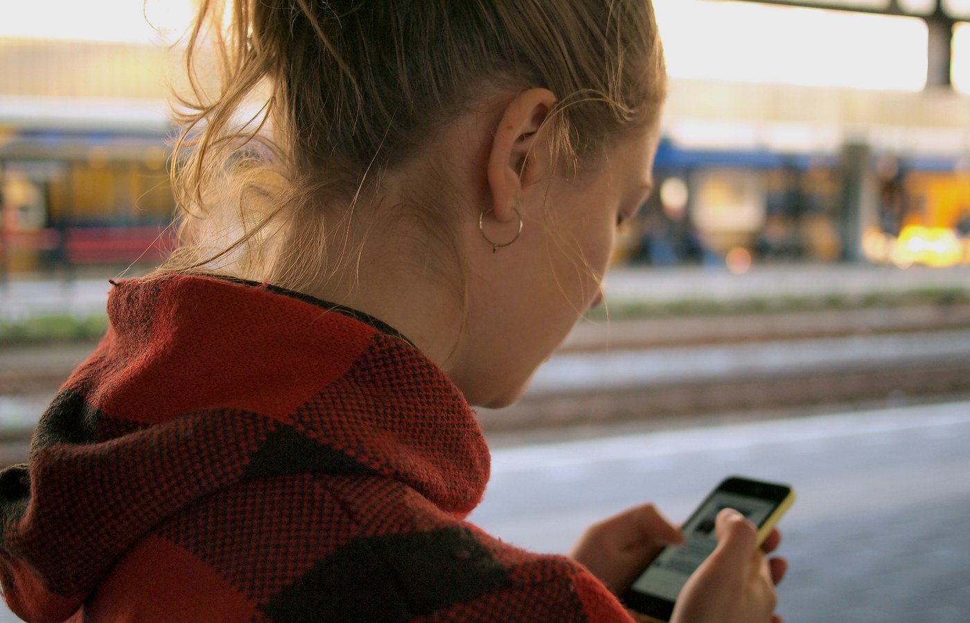 A woman evaluating a message on her phone